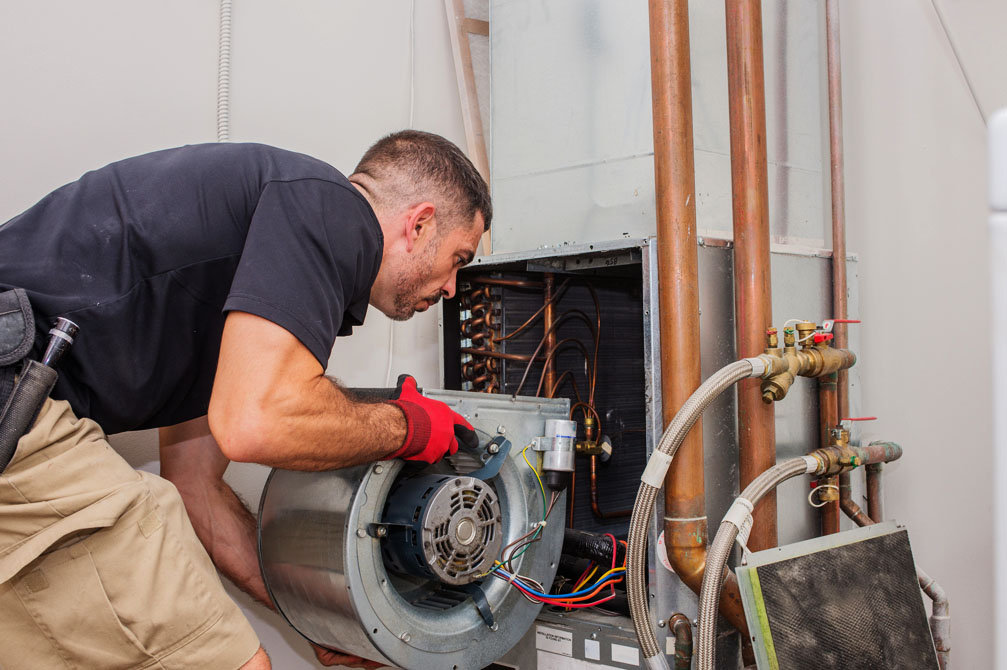 Technician installing furnace