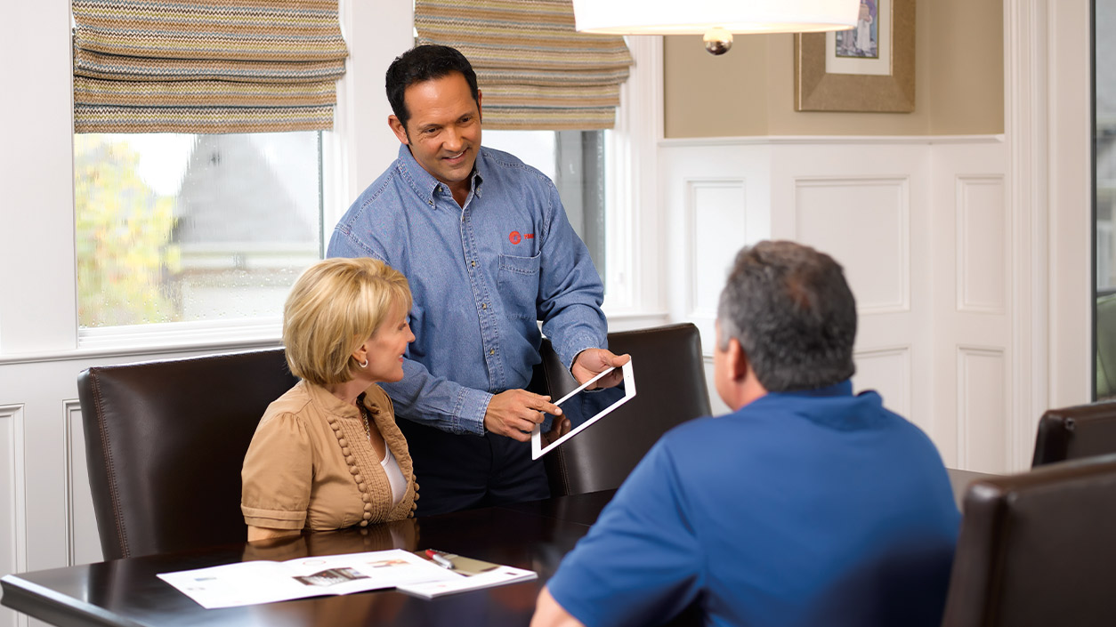 Technician with customers in home